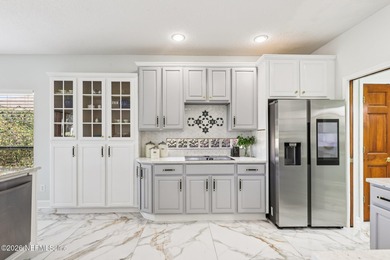 All brick two-story Eagle Harbor home with pond and fairway on Eagle Harbor Golf Club in Florida - for sale on GolfHomes.com, golf home, golf lot