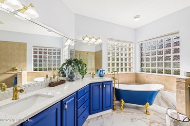 All brick two-story Eagle Harbor home with pond and fairway on Eagle Harbor Golf Club in Florida - for sale on GolfHomes.com, golf home, golf lot