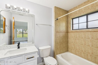 All brick two-story Eagle Harbor home with pond and fairway on Eagle Harbor Golf Club in Florida - for sale on GolfHomes.com, golf home, golf lot