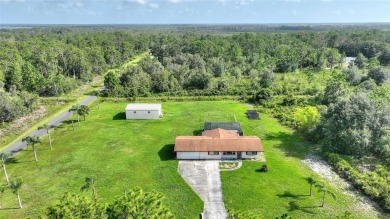 Exceptional Pool Home on 1 Acre in Indian Lake Estates - Golf on Indian Lake Estates Golf and Country Club in Florida - for sale on GolfHomes.com, golf home, golf lot