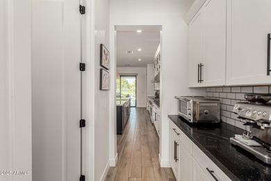 The modern Farmhouse ''St Helena'' model next to the Clubhouse on Sterling Grove Golf & Country Club in Arizona - for sale on GolfHomes.com, golf home, golf lot