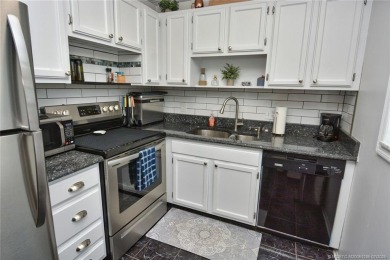 Updated dark floors add drama to the decor in this one bedroom 1 on Pine Lakes Golf Club in Florida - for sale on GolfHomes.com, golf home, golf lot