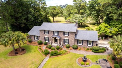 A stately two-story brick residence, exuding timeless elegance on Players Course At Wyboo Plantation in South Carolina - for sale on GolfHomes.com, golf home, golf lot