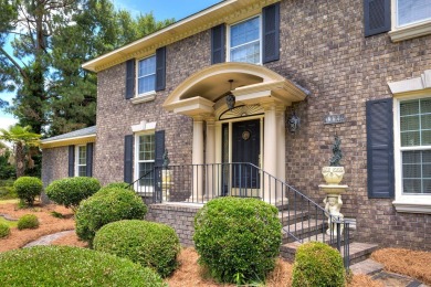 A stately two-story brick residence, exuding timeless elegance on Players Course At Wyboo Plantation in South Carolina - for sale on GolfHomes.com, golf home, golf lot