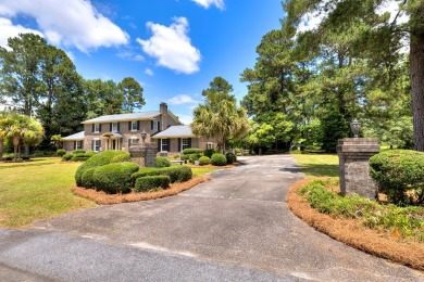 A stately two-story brick residence, exuding timeless elegance on Players Course At Wyboo Plantation in South Carolina - for sale on GolfHomes.com, golf home, golf lot