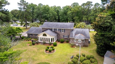 A stately two-story brick residence, exuding timeless elegance on Players Course At Wyboo Plantation in South Carolina - for sale on GolfHomes.com, golf home, golf lot