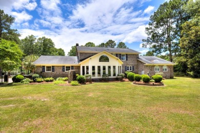 A stately two-story brick residence, exuding timeless elegance on Players Course At Wyboo Plantation in South Carolina - for sale on GolfHomes.com, golf home, golf lot