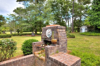 A stately two-story brick residence, exuding timeless elegance on Players Course At Wyboo Plantation in South Carolina - for sale on GolfHomes.com, golf home, golf lot