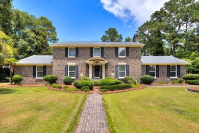 A stately two-story brick residence, exuding timeless elegance on Players Course At Wyboo Plantation in South Carolina - for sale on GolfHomes.com, golf home, golf lot