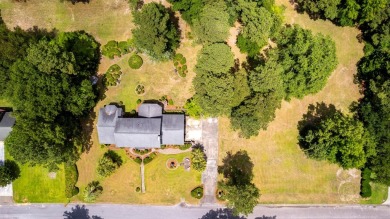 A stately two-story brick residence, exuding timeless elegance on Players Course At Wyboo Plantation in South Carolina - for sale on GolfHomes.com, golf home, golf lot