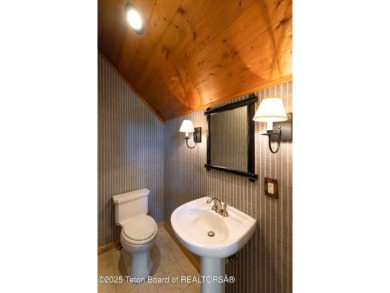 Bordering the 11th fairway of the prestigious Teton Pines golf on Teton Pines Golf Club in Wyoming - for sale on GolfHomes.com, golf home, golf lot