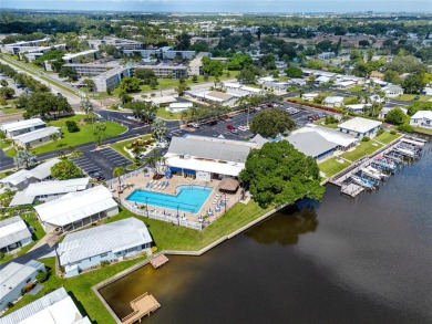 Florida Living at Its Finest in Sought-After Americana Cove - on Mangrove Bay Golf Course in Florida - for sale on GolfHomes.com, golf home, golf lot