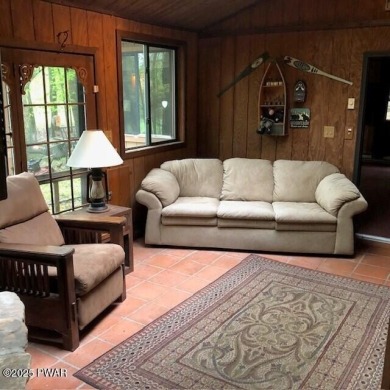 Tanglwood Lakes sprawling home situated on a level wooded lot on Paupack Hills Golf and Country Club in Pennsylvania - for sale on GolfHomes.com, golf home, golf lot