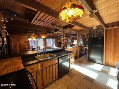 Tanglwood Lakes sprawling home situated on a level wooded lot on Paupack Hills Golf and Country Club in Pennsylvania - for sale on GolfHomes.com, golf home, golf lot