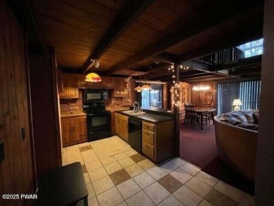 Tanglwood Lakes sprawling home situated on a level wooded lot on Paupack Hills Golf and Country Club in Pennsylvania - for sale on GolfHomes.com, golf home, golf lot