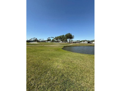 Panoramic golf and water views from this great home in The on Hamptons Golf Club in Florida - for sale on GolfHomes.com, golf home, golf lot