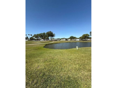 Panoramic golf and water views from this great home in The on Hamptons Golf Club in Florida - for sale on GolfHomes.com, golf home, golf lot