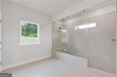 Nestled in the sought-after Traditions of Braselton community on Traditions of Braselton Golf Club in Georgia - for sale on GolfHomes.com, golf home, golf lot