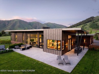 Perched above the Snake River with commanding views of Wolf on Snake River Sporting Club in Wyoming - for sale on GolfHomes.com, golf home, golf lot