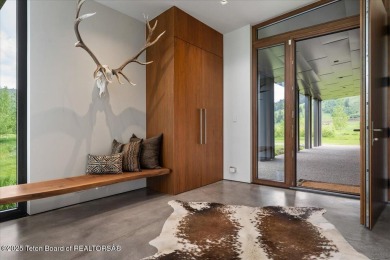 Perched above the Snake River with commanding views of Wolf on Snake River Sporting Club in Wyoming - for sale on GolfHomes.com, golf home, golf lot