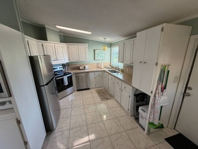 This well-cared for Palm Harbor stucco home provides beautiful on Del Tura Golf and Country Club in Florida - for sale on GolfHomes.com, golf home, golf lot