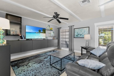 IT IS ALL ABOUT THE LOCATION. This home sits on a lake looking on Island Country Club in Florida - for sale on GolfHomes.com, golf home, golf lot