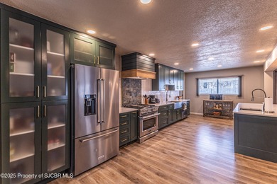 This impeccably maintained single-level mid-century home is on San Juan Country Club in New Mexico - for sale on GolfHomes.com, golf home, golf lot