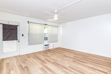 Beautifully remodeled first-floor unit filled with natural light on Hillsboro Pines Golf in Florida - for sale on GolfHomes.com, golf home, golf lot