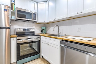 Beautifully remodeled first-floor unit filled with natural light on Hillsboro Pines Golf in Florida - for sale on GolfHomes.com, golf home, golf lot