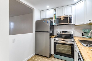 Beautifully remodeled first-floor unit filled with natural light on Hillsboro Pines Golf in Florida - for sale on GolfHomes.com, golf home, golf lot