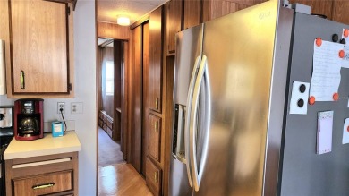 DOUBLE WIDE MOBILE HOME in active 55+ community. FIXER-UPPER IS on River Run Golf Links in Florida - for sale on GolfHomes.com, golf home, golf lot