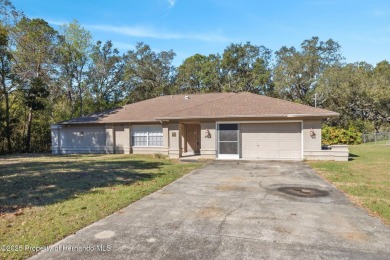 Discover the essence of Florida living in this charming on Oak Hills Country Club in Florida - for sale on GolfHomes.com, golf home, golf lot