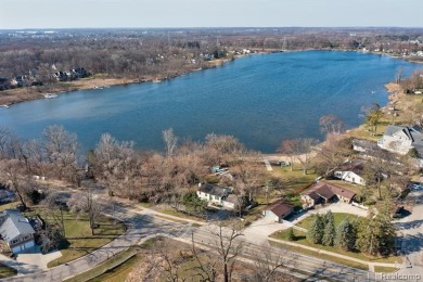 Welcome to your dream home nestled on the shores of beautiful on Hickory Hill Golf Course in Michigan - for sale on GolfHomes.com, golf home, golf lot