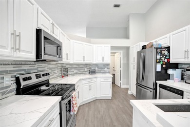 ENJOY LIVING & RELAXING IN THIS GORGEOUS REMODELED HOME WITH on Woodmont Country Club in Florida - for sale on GolfHomes.com, golf home, golf lot