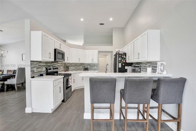 ENJOY LIVING & RELAXING IN THIS GORGEOUS REMODELED HOME WITH on Woodmont Country Club in Florida - for sale on GolfHomes.com, golf home, golf lot