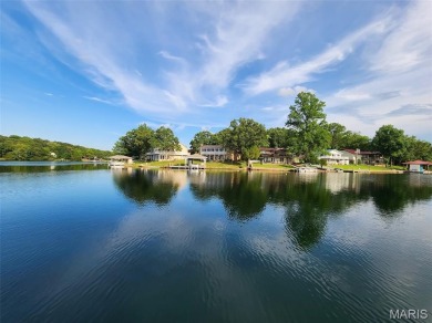 Enjoy stunning sunset lake views from this charming all-brick on Terre Du Lac Golf and Country Club in Missouri - for sale on GolfHomes.com, golf home, golf lot