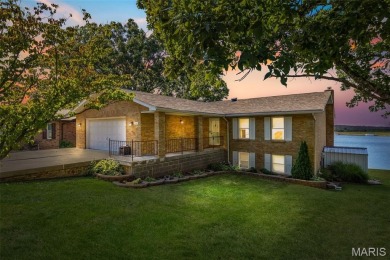 Enjoy stunning sunset lake views from this charming all-brick on Terre Du Lac Golf and Country Club in Missouri - for sale on GolfHomes.com, golf home, golf lot