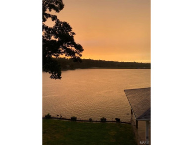 Enjoy stunning sunset lake views from this charming all-brick on Terre Du Lac Golf and Country Club in Missouri - for sale on GolfHomes.com, golf home, golf lot