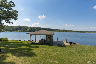 Enjoy stunning sunset lake views from this charming all-brick on Terre Du Lac Golf and Country Club in Missouri - for sale on GolfHomes.com, golf home, golf lot