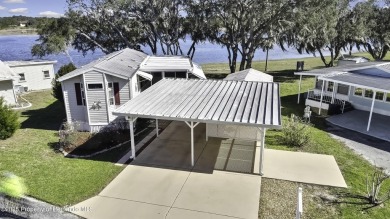 Welcome to paradise!  This lakefront home on Tooke Lake is on Glen Lakes Country Club in Florida - for sale on GolfHomes.com, golf home, golf lot