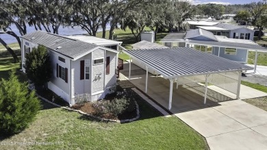 Welcome to paradise!  This lakefront home on Tooke Lake is on Glen Lakes Country Club in Florida - for sale on GolfHomes.com, golf home, golf lot