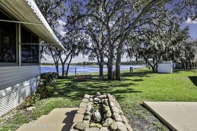 Welcome to paradise!  This lakefront home on Tooke Lake is on Glen Lakes Country Club in Florida - for sale on GolfHomes.com, golf home, golf lot