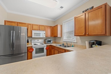 This charming 2-bedroom, 2-bathroom second-floor end unit is on Barefoot Resort and Golf Club  in South Carolina - for sale on GolfHomes.com, golf home, golf lot