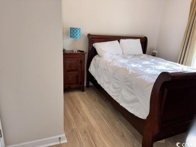 This charming 2-bedroom, 2-bathroom second-floor end unit is on Barefoot Resort and Golf Club  in South Carolina - for sale on GolfHomes.com, golf home, golf lot