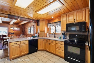 This stunning custom log home on Hole #1 of Aspen Hills Golf on Star Valley RV Golf Course in Wyoming - for sale on GolfHomes.com, golf home, golf lot