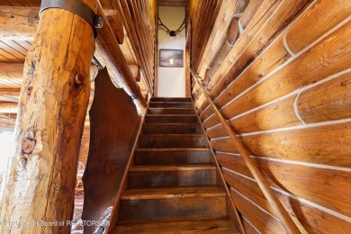 This stunning custom log home on Hole #1 of Aspen Hills Golf on Star Valley RV Golf Course in Wyoming - for sale on GolfHomes.com, golf home, golf lot