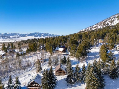 This stunning custom log home on Hole #1 of Aspen Hills Golf on Star Valley RV Golf Course in Wyoming - for sale on GolfHomes.com, golf home, golf lot