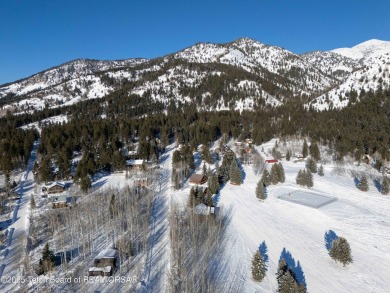 This stunning custom log home on Hole #1 of Aspen Hills Golf on Star Valley RV Golf Course in Wyoming - for sale on GolfHomes.com, golf home, golf lot