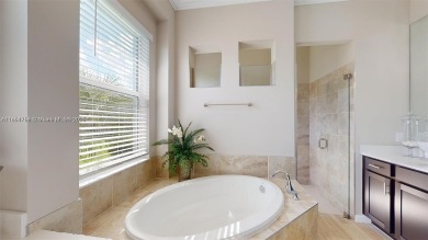 This stunning home boasts panoramic views of the lake and golf on Panther Run Golf Club in Florida - for sale on GolfHomes.com, golf home, golf lot