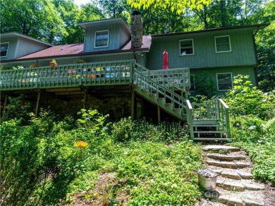 This contemporary mountain home situated on a private wooded lot on Mt. Mitchell Golf Course in North Carolina - for sale on GolfHomes.com, golf home, golf lot